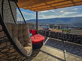 The hanging chair on the rooftop, looking out over Kigali's hills