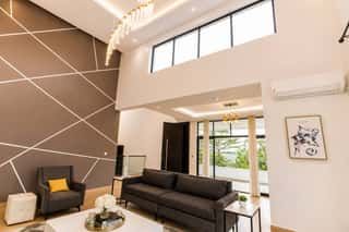 The double-height living room, with tall windows