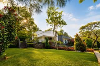 The lawn, with the villa among the trees