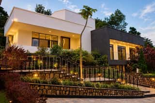The terraced garden and villa, lit at dusk