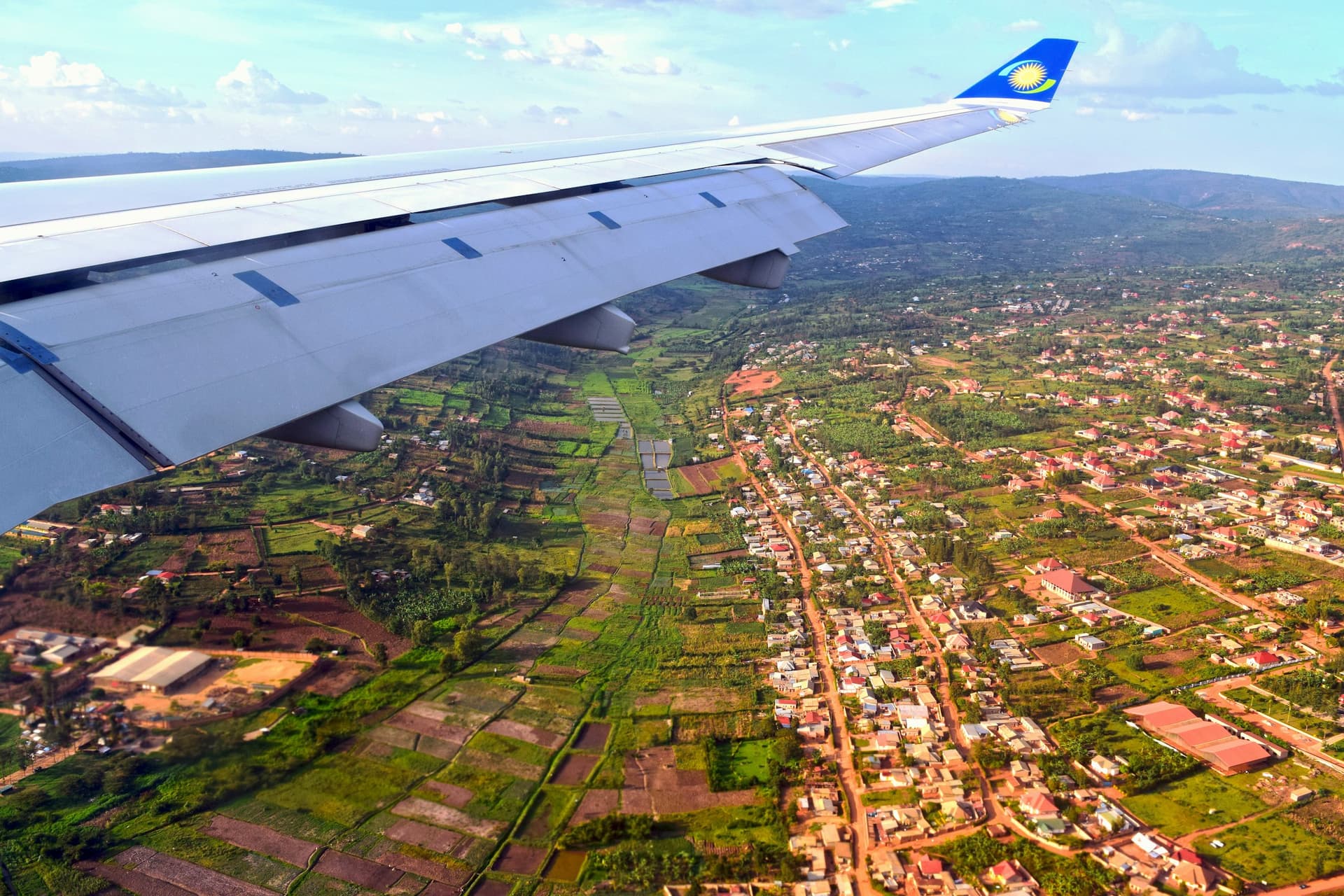 A RwandAir wing above the hills of Kigali, on approach