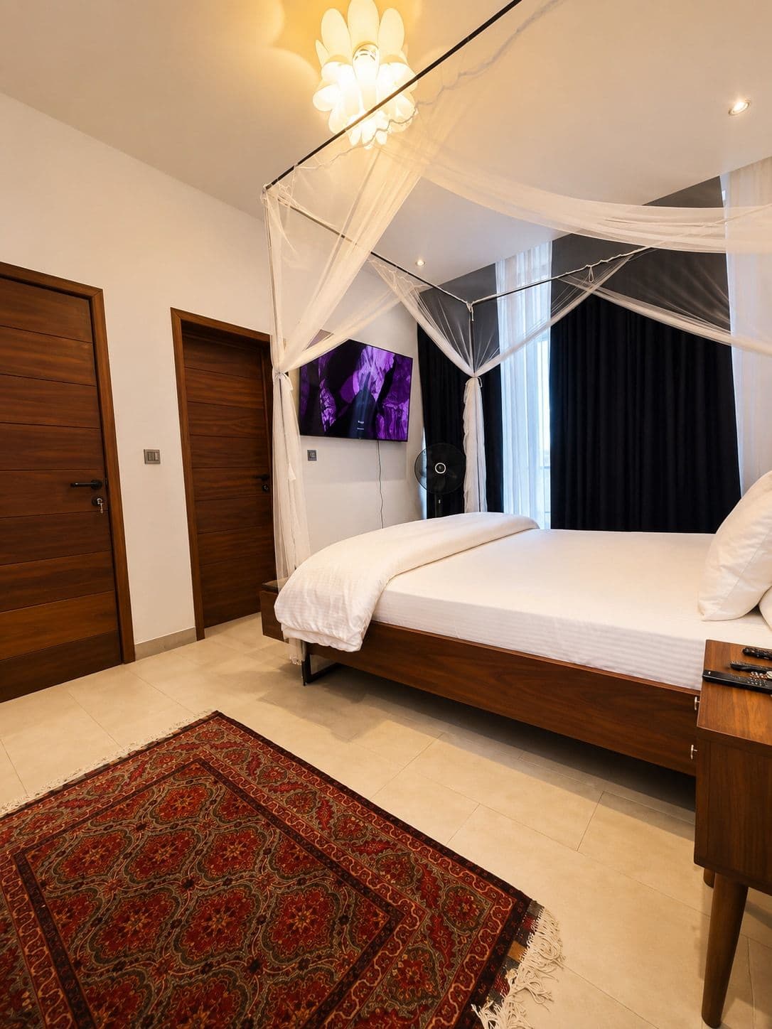 The principal suite at Ikaze, a bed under a mosquito net in soft light, Niboye, Kigali