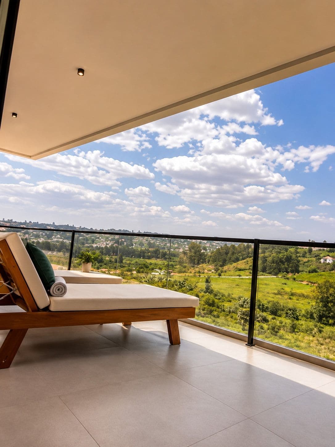 A lounger on the balcony, with a wide view over the Kigali valley. Amahoro, Kibagabaga.