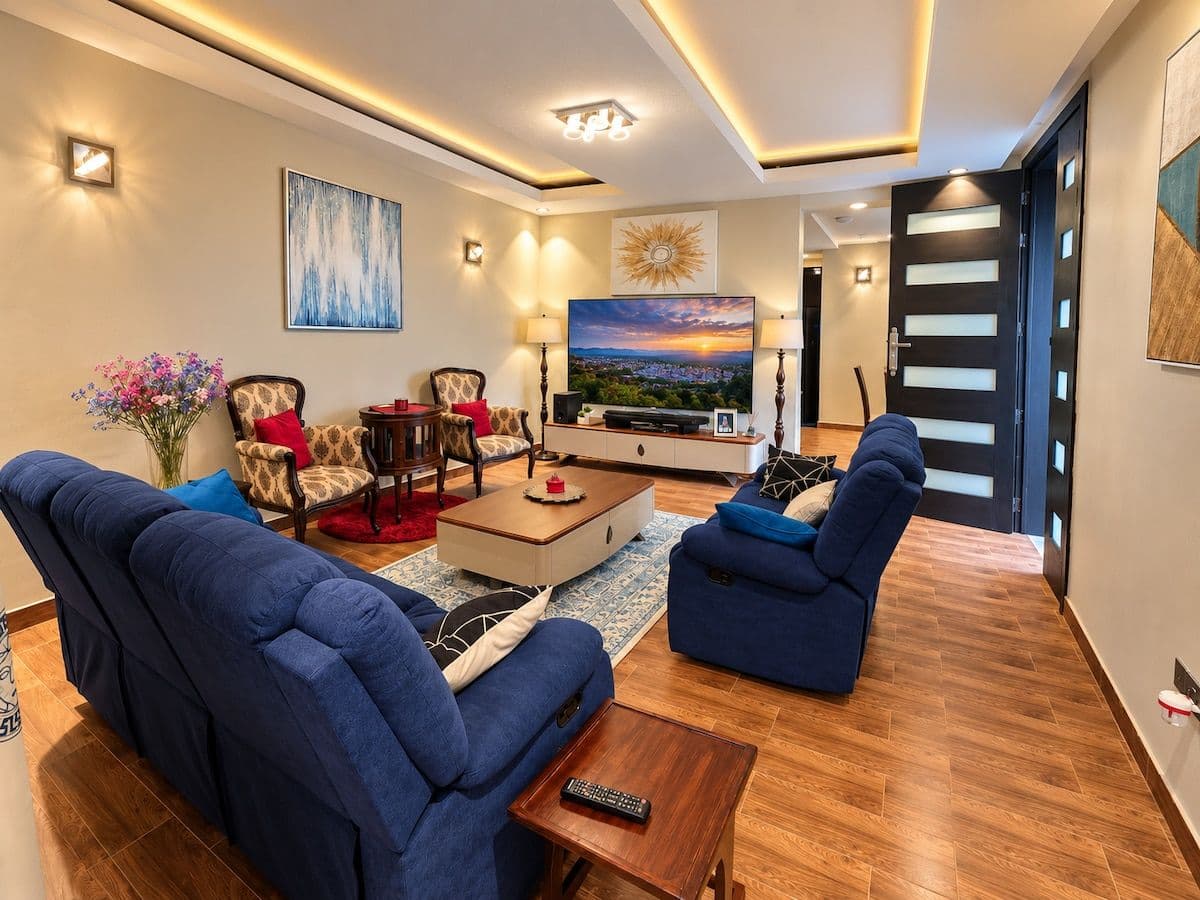 The living room seating, with a patterned rug and wall lights. Irebero, Rebero.