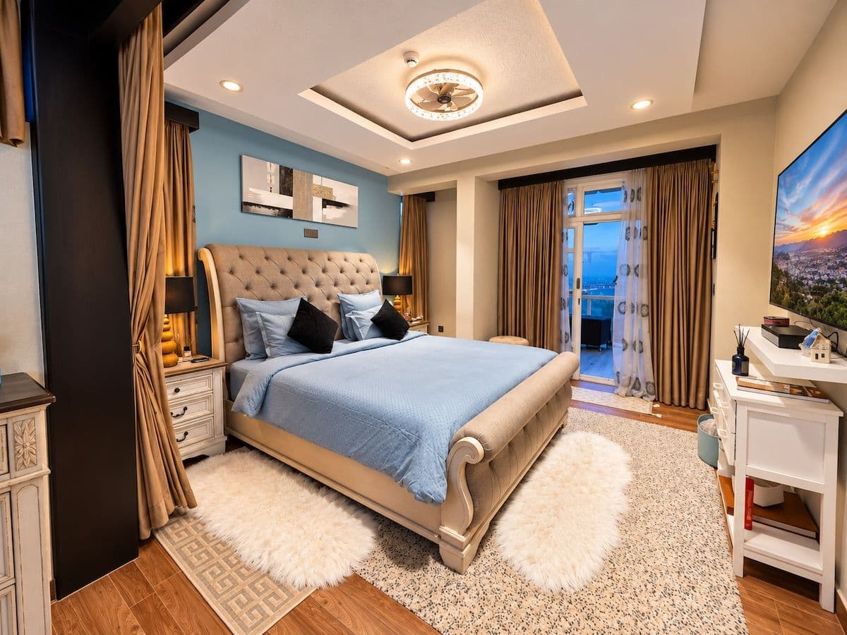 The principal bedroom, with the bed facing the balcony doors and the evening view. Irebero, Rebero.