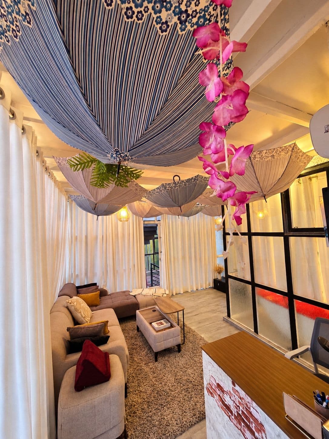 The sitting nook, with orchids and the umbrella canopy overhead. Irebero, Rebero.
