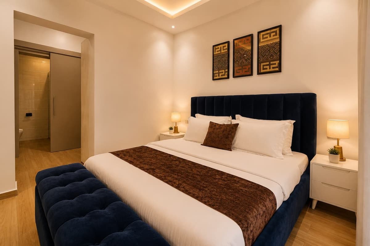 The king bed in Urugwiro's principal suite, in warm lamplight, Kacyiru, Kigali