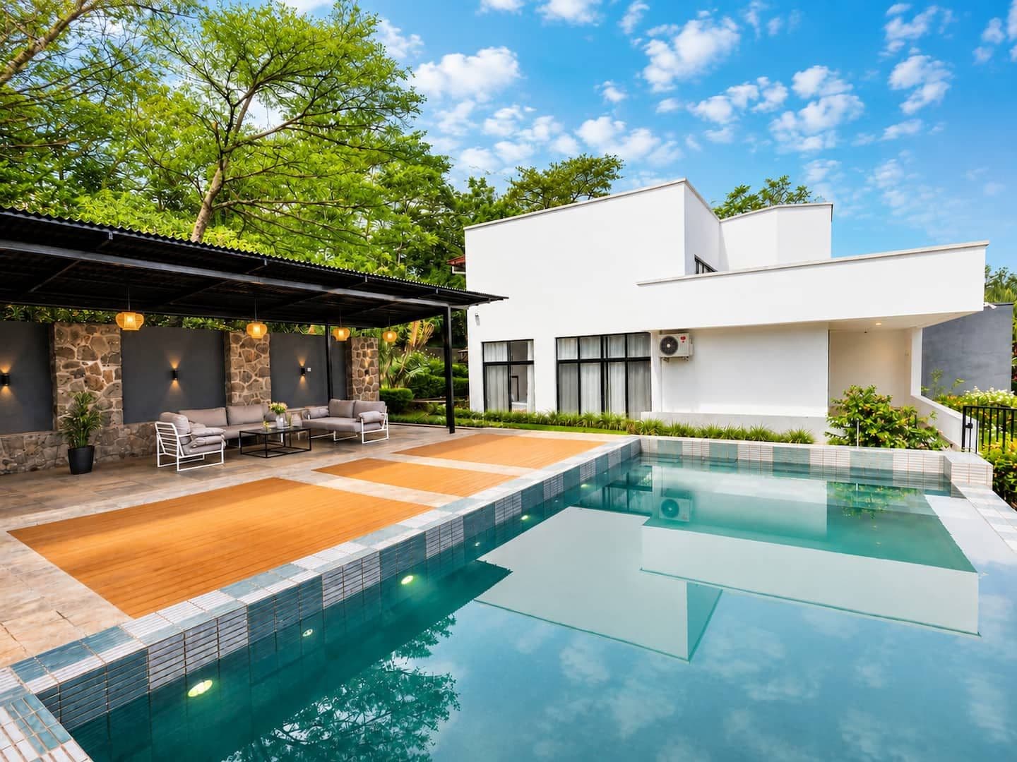 The pool and its covered lounge beneath a blue sky. Urugwiro, Kacyiru.