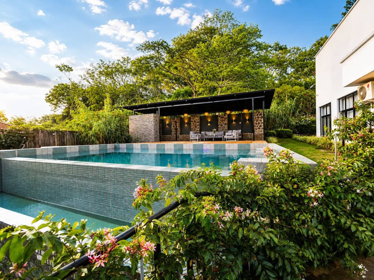 The infinity pool edge and the pavilion, among the trees. Urugwiro, Kacyiru.